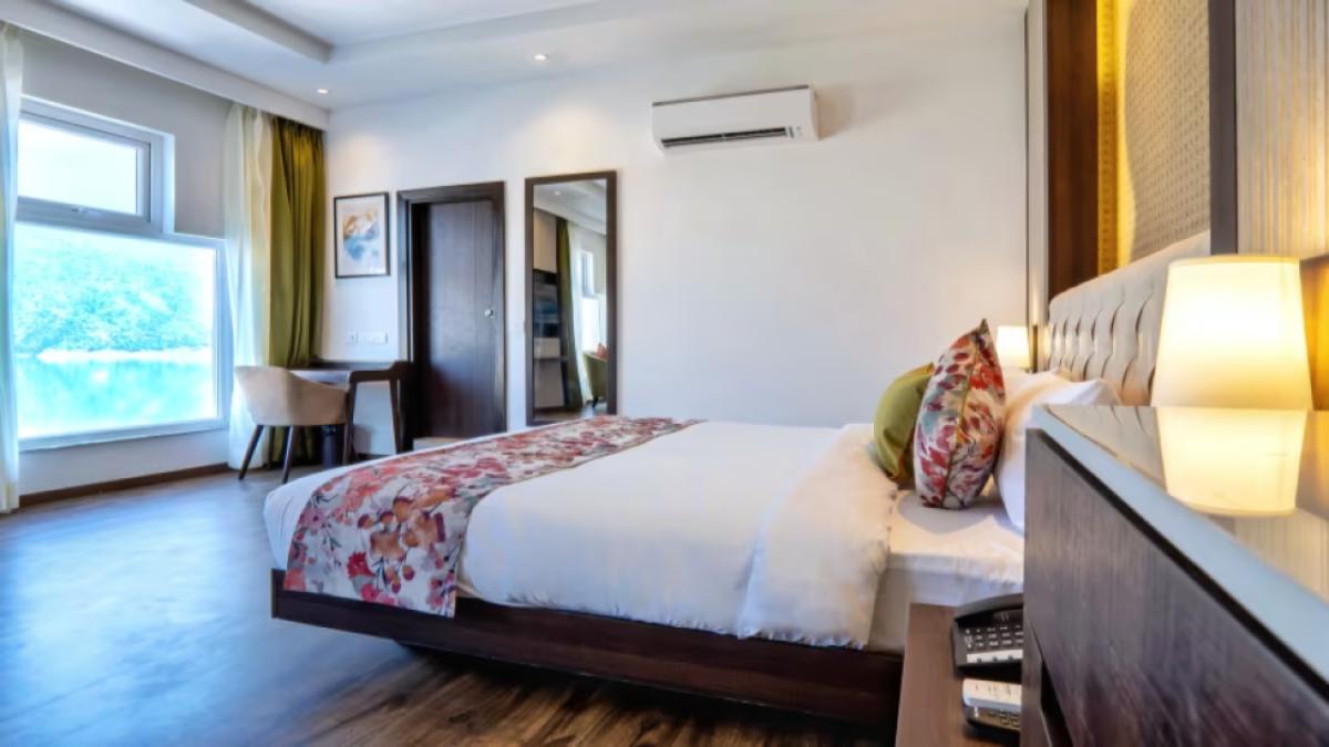 Premium_Rooms_with_Lake_View_at_Hotel_Le_ROI_Lake_View_Koti_with_a_beautiful_view_from_the_window_next_to_the_plush_bed3_tclxvs